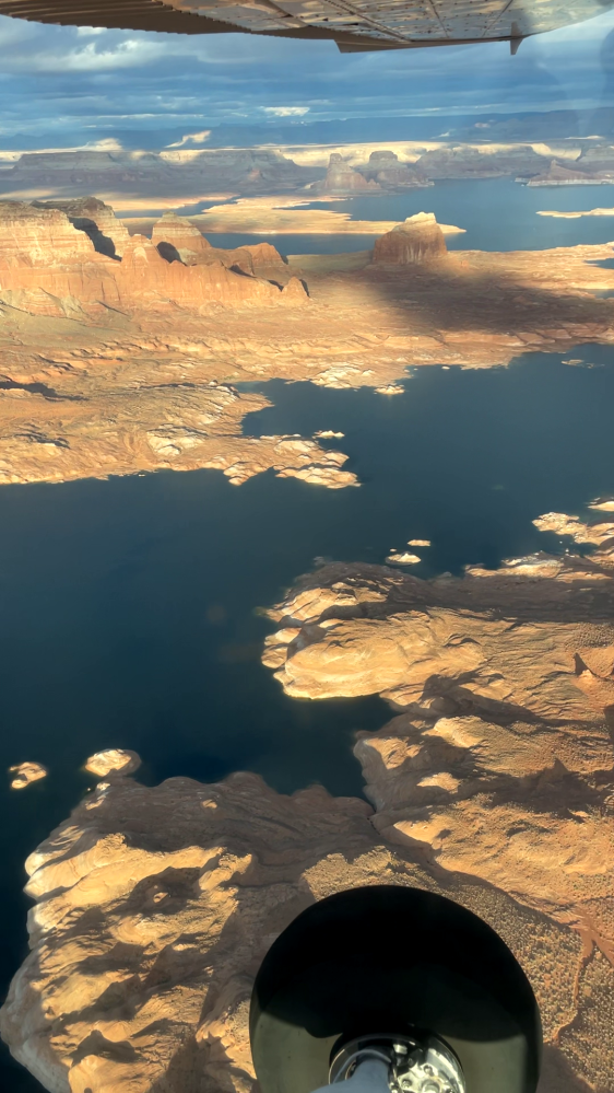 Aerial view of a canyon landscape with water bodies and rock formations.