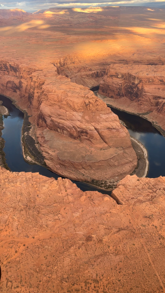 Aerial view of Horseshoe Bend with a river curving around red rock formations.